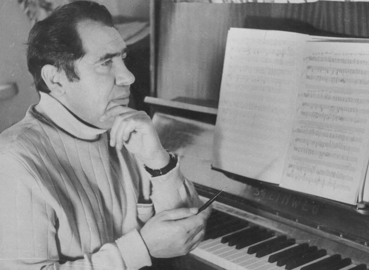 Gheorghe Neaga at a piano with an open score and pencil